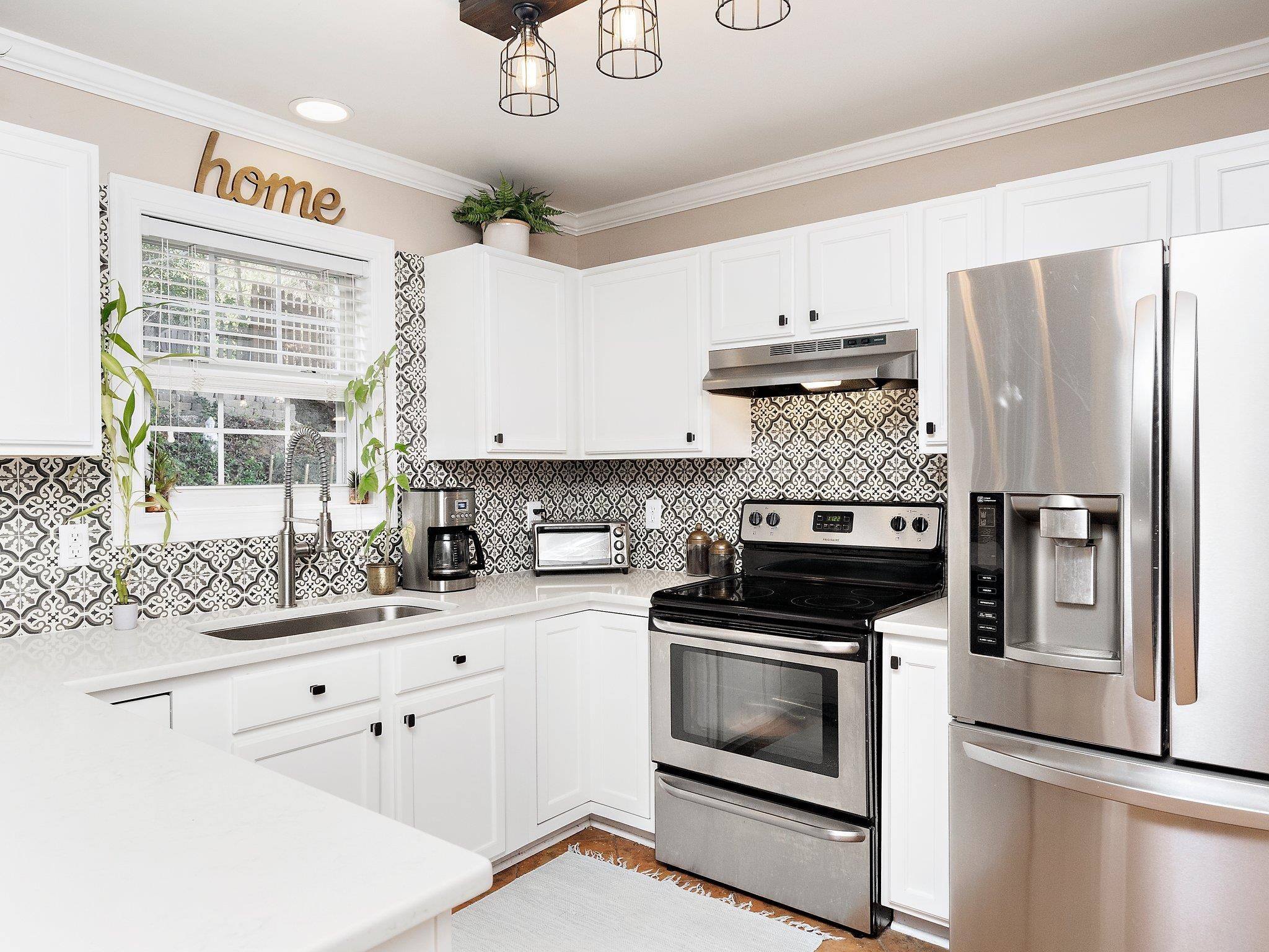 8312 Hobhouse Circle Raleigh, NC 27615 - Photo 13 of 39 a kitchen with cabinets stainless steel appliances and a counter space