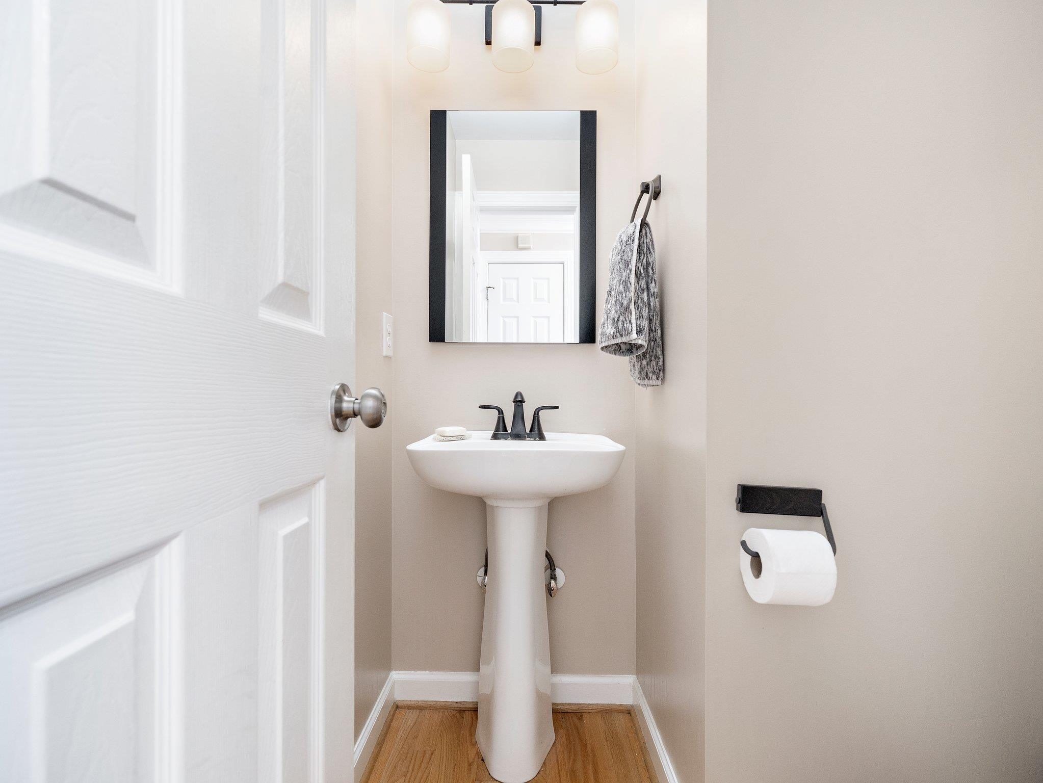 8312 Hobhouse Circle Raleigh, NC 27615 - Photo 16 of 39 a bathroom with a sink a mirror and toilet