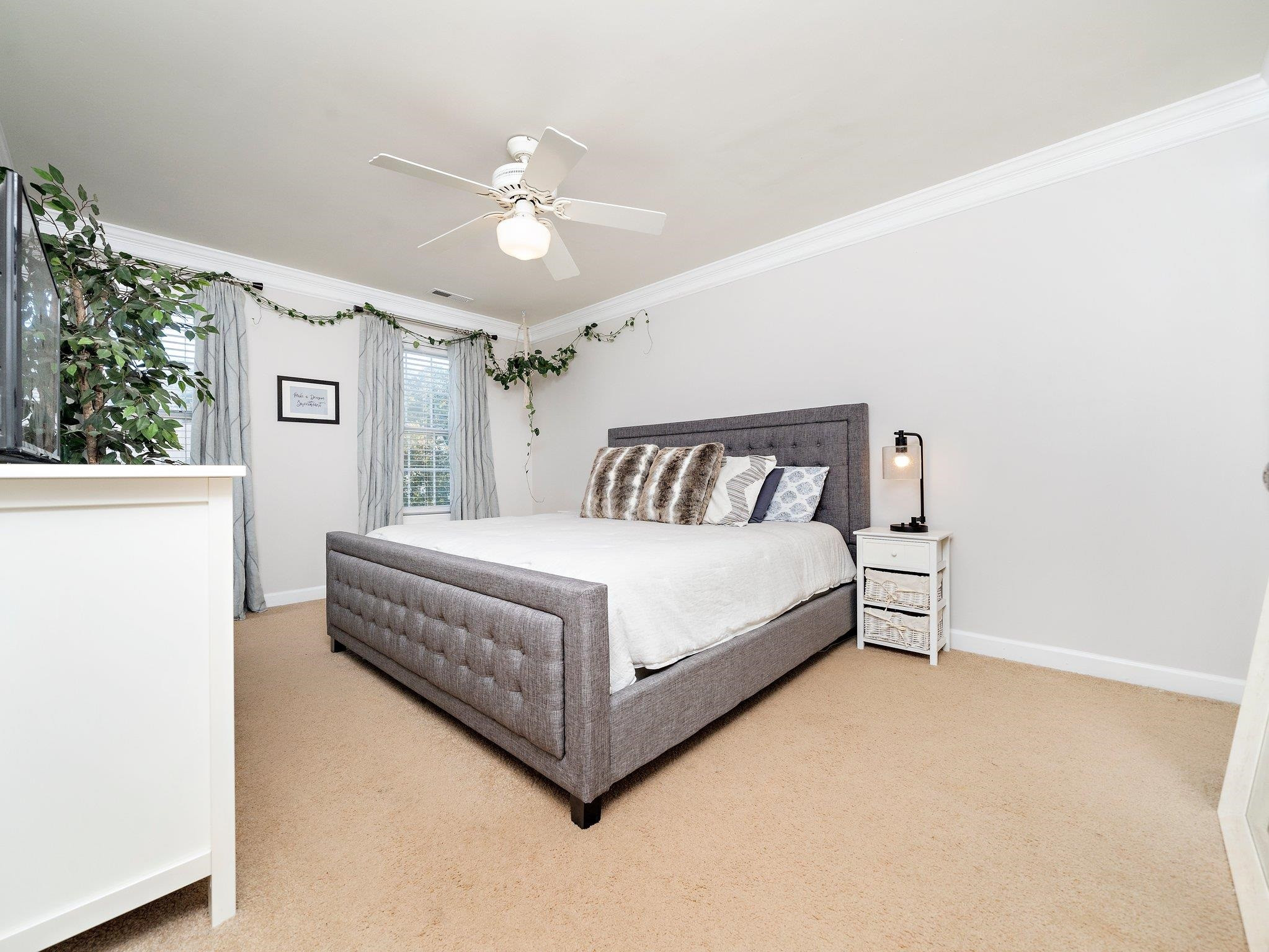 8312 Hobhouse Circle Raleigh, NC 27615 - Photo 17 of 39 a bedroom with a bed and a chandelier