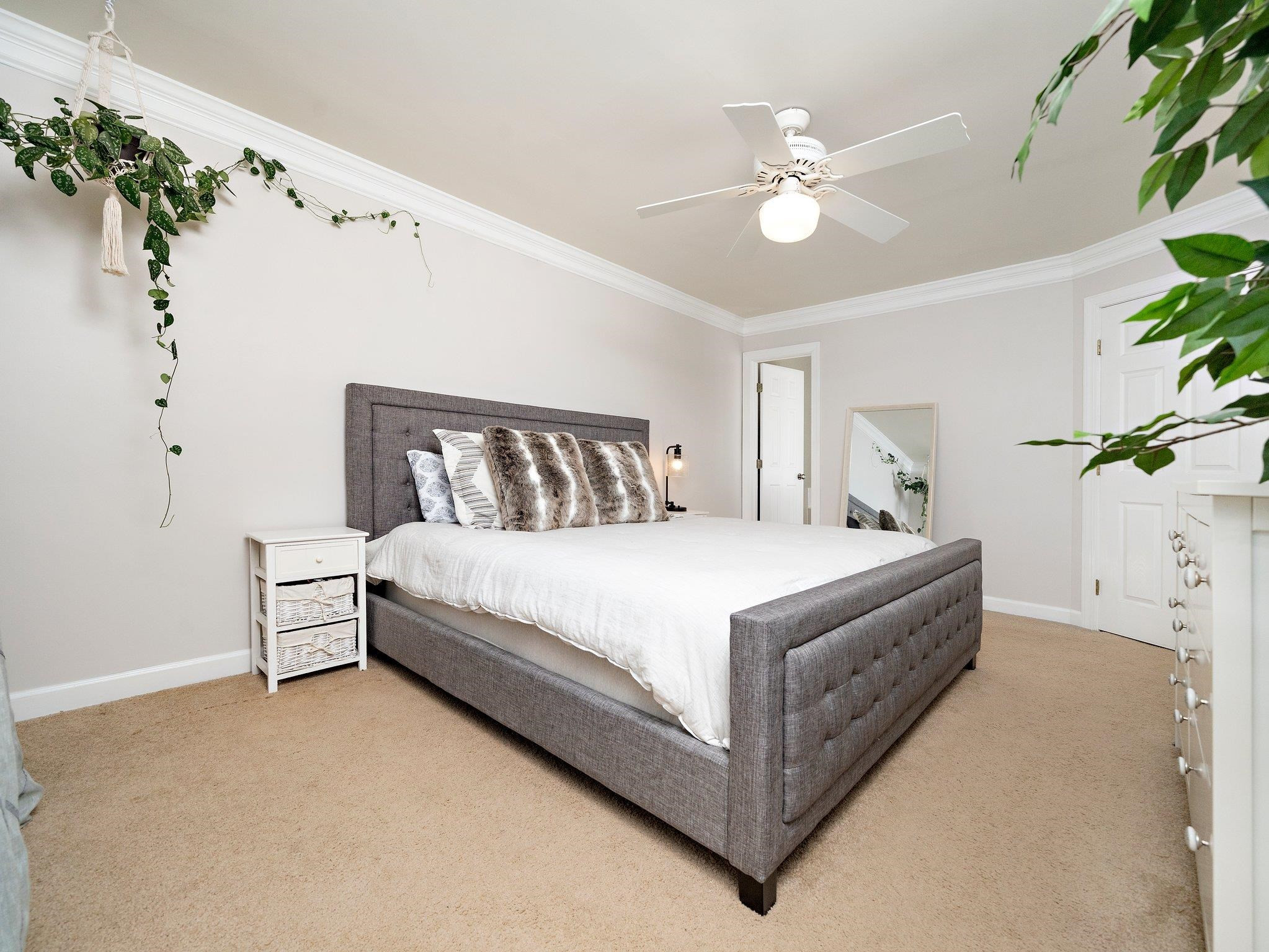 8312 Hobhouse Circle Raleigh, NC 27615 - Photo 18 of 39 a spacious bedroom with a bed and a chandelier