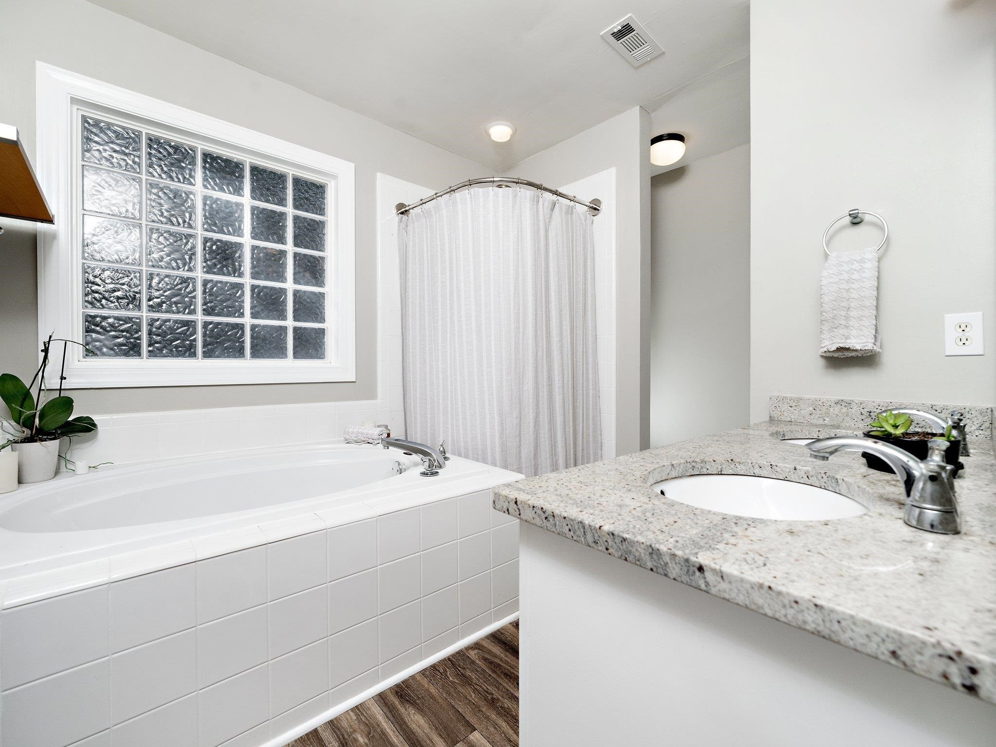 8312 Hobhouse Circle Raleigh, NC 27615 - Photo 20 of 39 a bathroom with a granite countertop sink and a bathtub