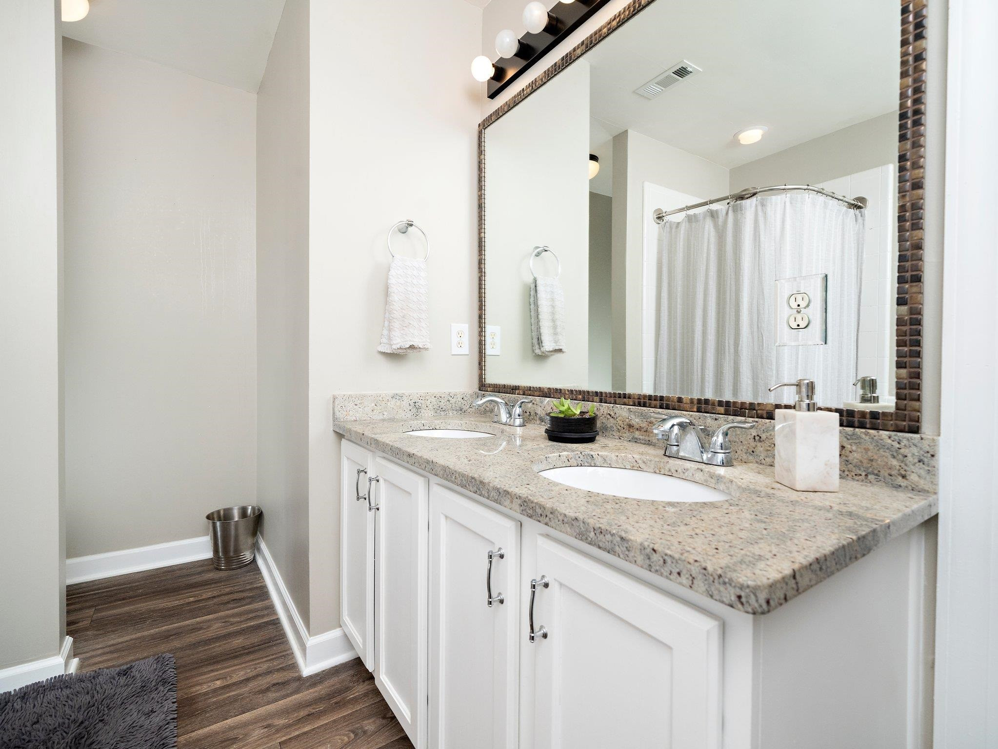 8312 Hobhouse Circle Raleigh, NC 27615 - Photo 21 of 39 a bathroom with a granite countertop sink and a mirror