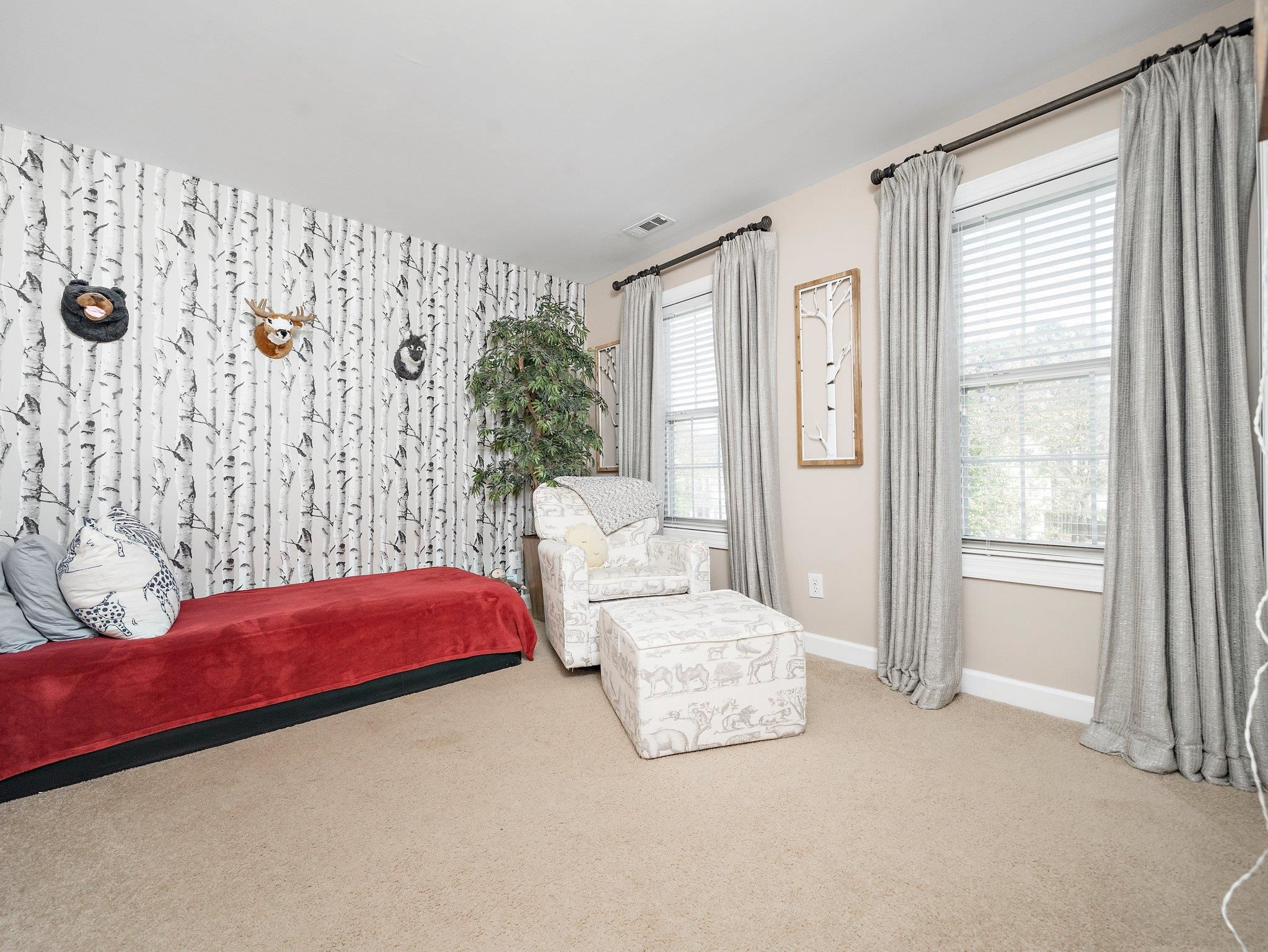 8312 Hobhouse Circle Raleigh, NC 27615 - Photo 22 of 39 a bedroom with a bed and a couch