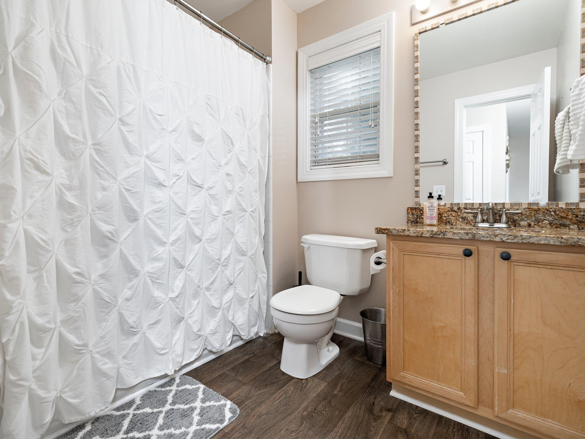 8312 Hobhouse Circle Raleigh, NC 27615 - Photo 24 of 39 a bathroom with a toilet sink and a mirror