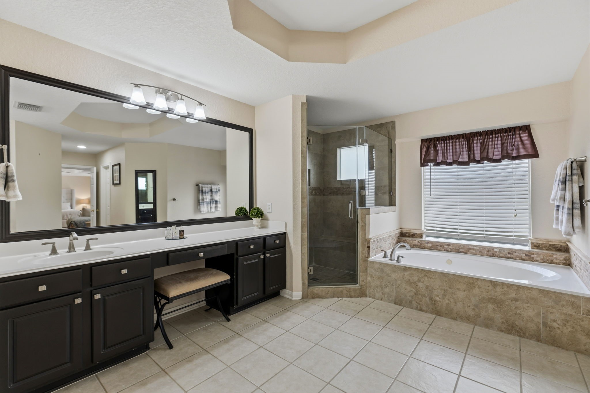 20102 Windbury Court Spring, TX 77379 - Photo 22 of 49 a spacious bathroom with a granite countertop sink mirror and bathtub