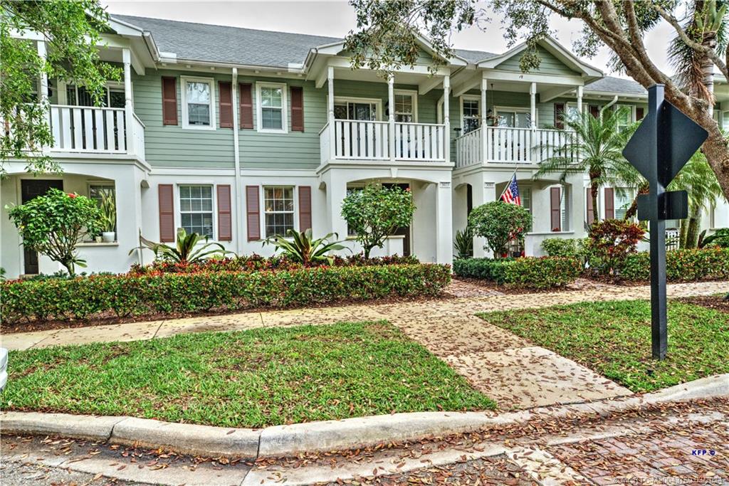 3073 East Community Drive Jupiter, FL 33458 - Photo 2 of 85 a front view of a house with a yard