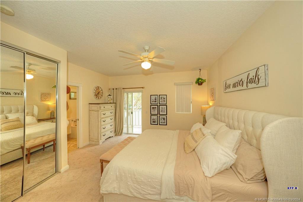3073 East Community Drive Jupiter, FL 33458 - Photo 23 of 85 a spacious bedroom with a bed and a shower