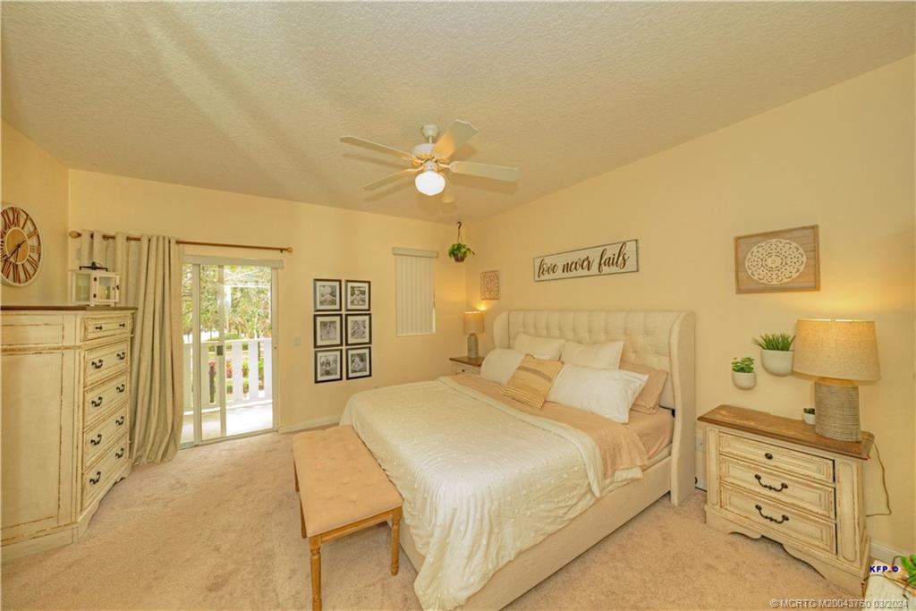 3073 East Community Drive Jupiter, FL 33458 - Photo 27 of 85 a bed room with a bed and a chandelier