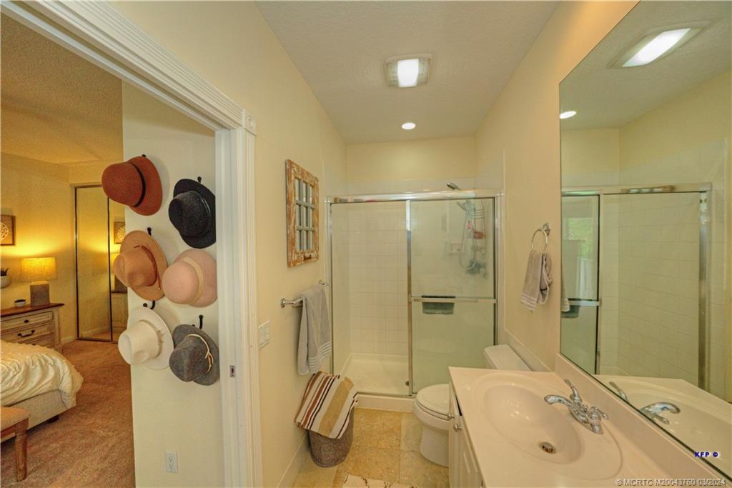 3073 East Community Drive Jupiter, FL 33458 - Photo 29 of 85 a bathroom with a sink mirror and shower