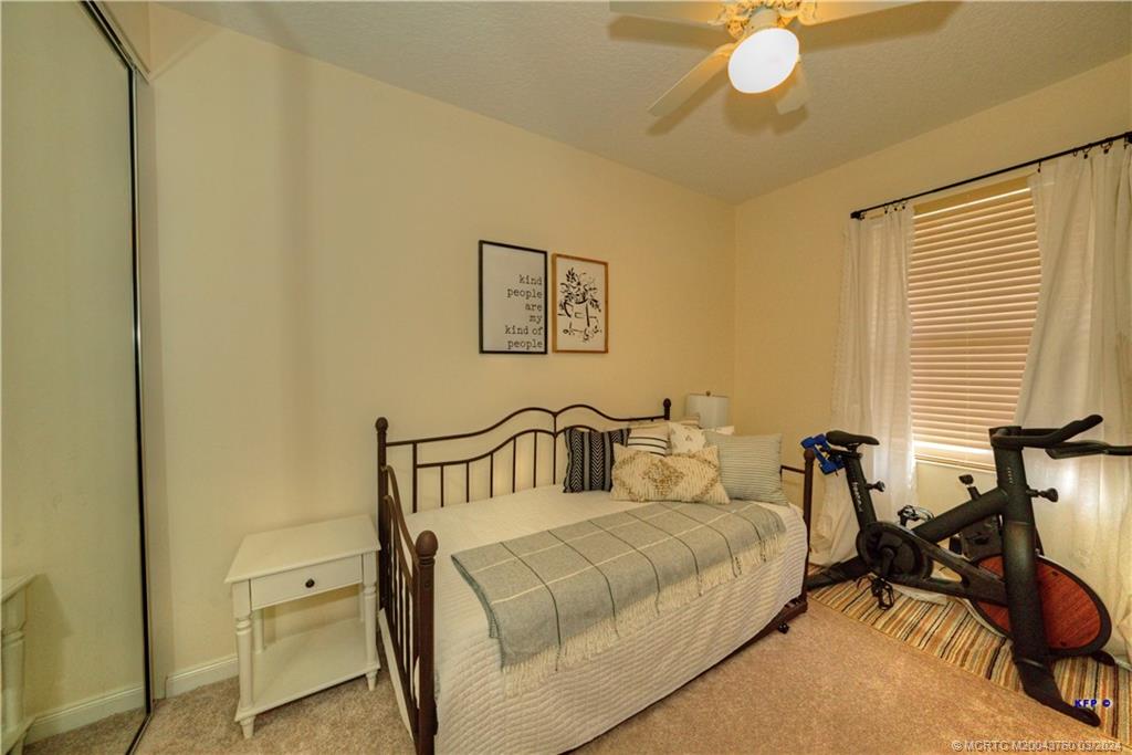 3073 East Community Drive Jupiter, FL 33458 - Photo 41 of 85 a bedroom with a bed and cabinets
