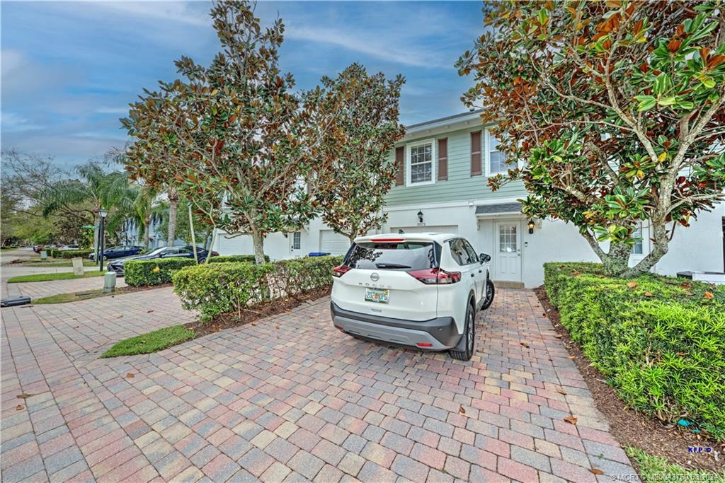 3073 East Community Drive Jupiter, FL 33458 - Photo 44 of 85 a front view of a house with a yard