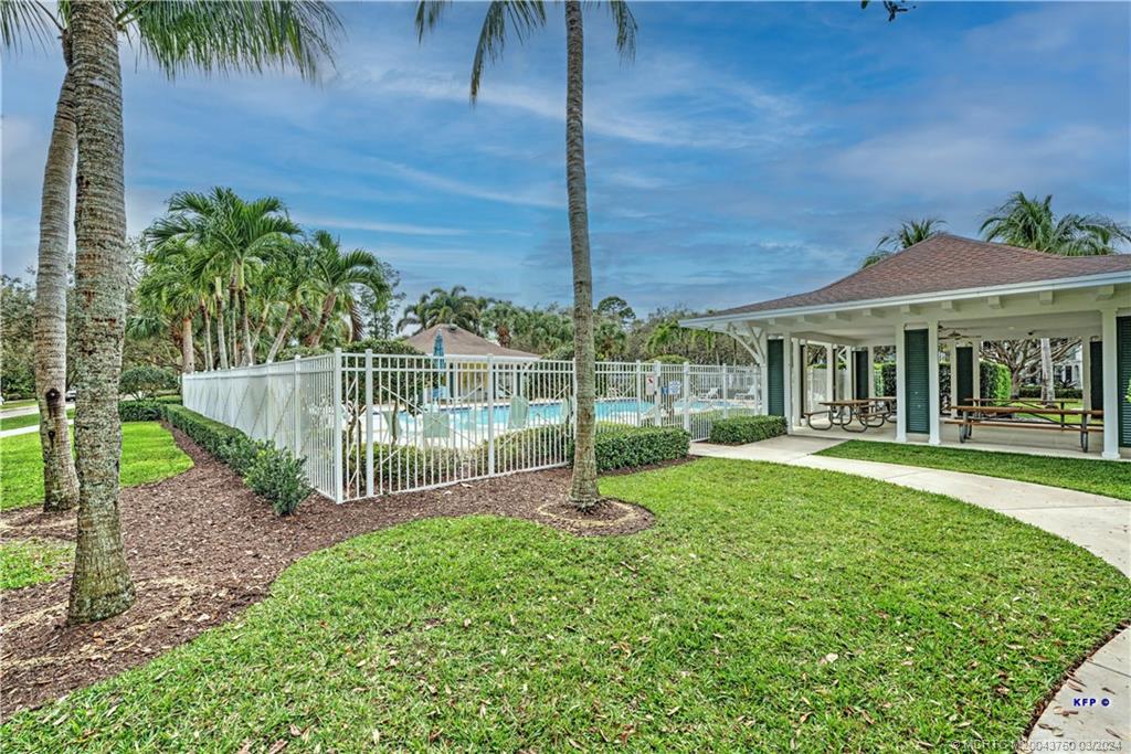 3073 East Community Drive Jupiter, FL 33458 - Photo 53 of 85 a front view of a house with a yard table and chairs