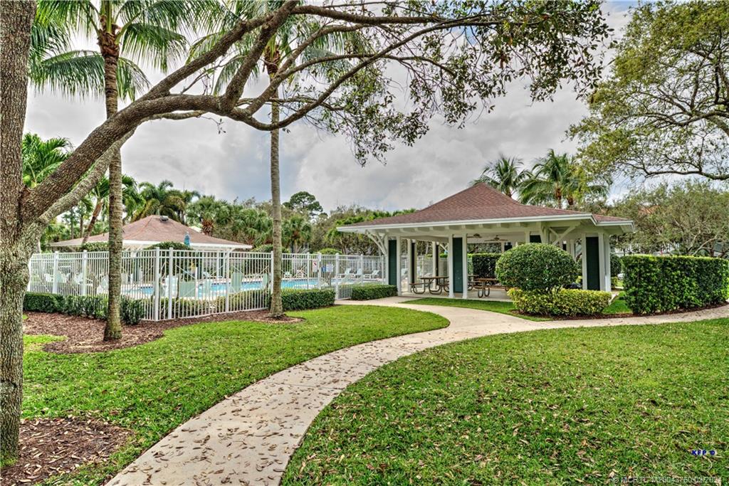 3073 East Community Drive Jupiter, FL 33458 - Photo 55 of 85 a front view of a house with a yard table and chairs