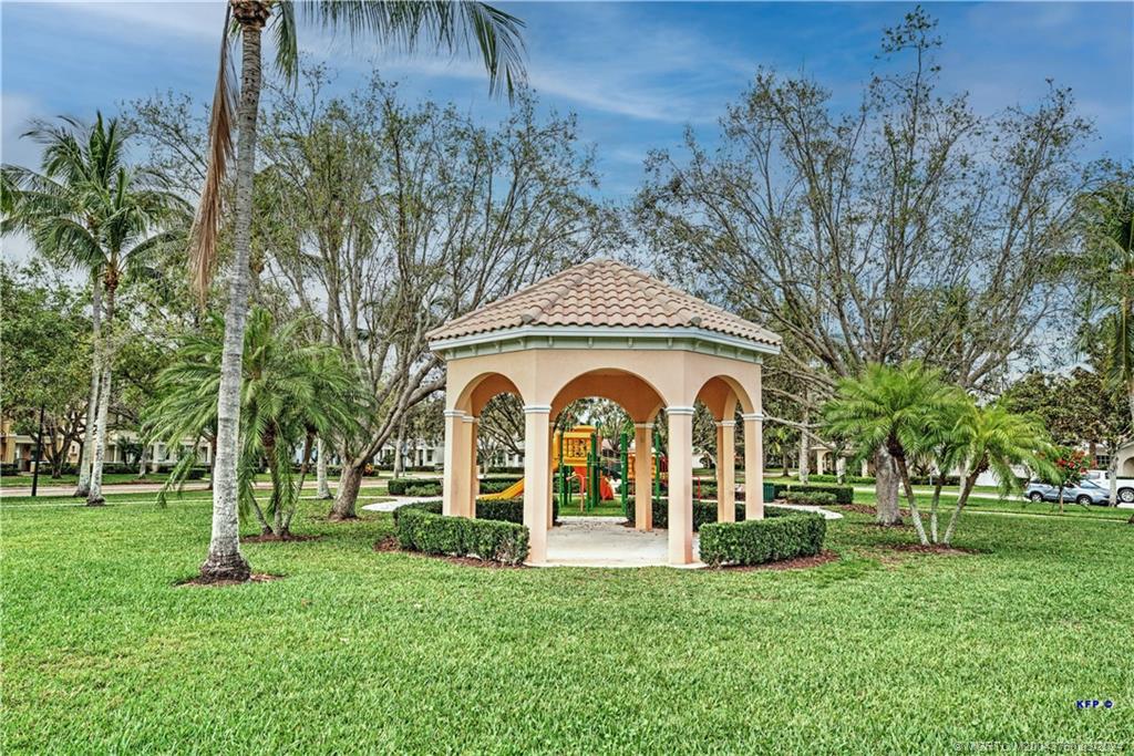 3073 East Community Drive Jupiter, FL 33458 - Photo 58 of 85 a front view of a house with garden