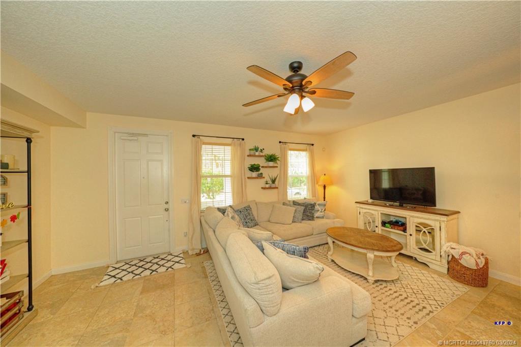 3073 East Community Drive Jupiter, FL 33458 - Photo 6 of 85 a living room with furniture and a flat screen tv