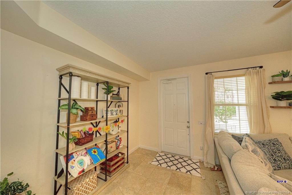 3073 East Community Drive Jupiter, FL 33458 - Photo 7 of 85 a bedroom with a bed and a window