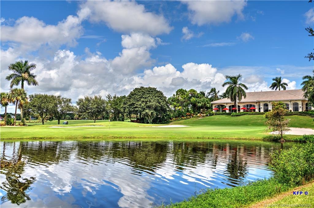 3073 East Community Drive Jupiter, FL 33458 - Photo 79 of 85 a view of a lake with a house in the background