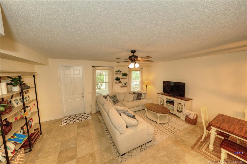 3073 East Community Drive Jupiter, FL 33458 - Photo 8 of 85 a bedroom with furniture and a flat screen tv