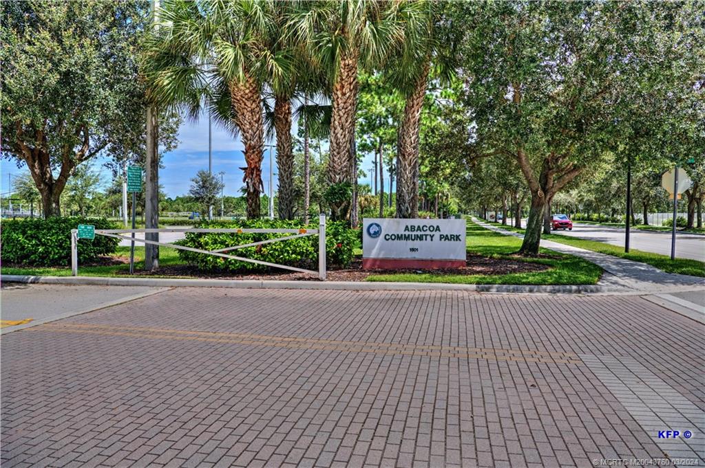 3073 East Community Drive Jupiter, FL 33458 - Photo 82 of 85 a front view of a house with a yard and trees