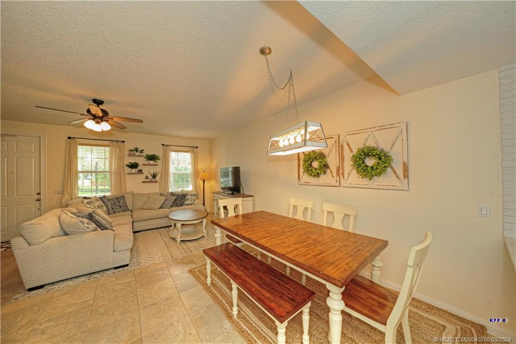 3073 East Community Drive Jupiter, FL 33458 - Photo 10 of 85 a living room with furniture and a chandelier
