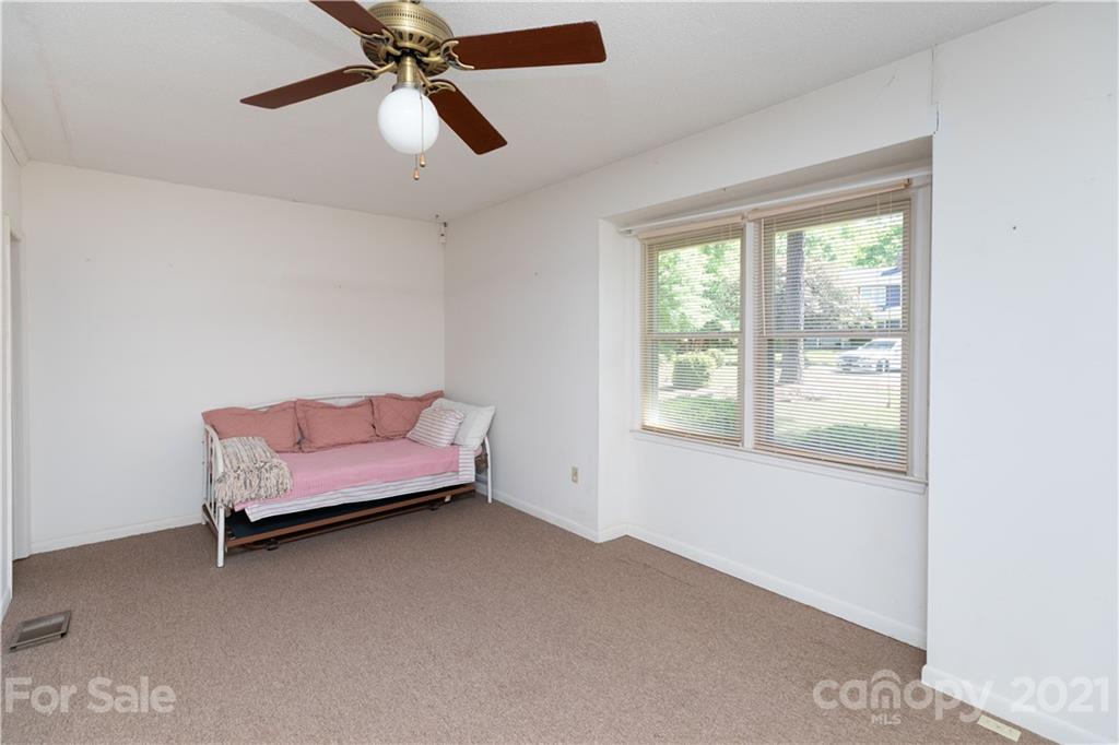 11 Friendfield Court Fort Mill, SC 29715 - Photo 13 of 32 a bedroom with a bed and a chandelier fan