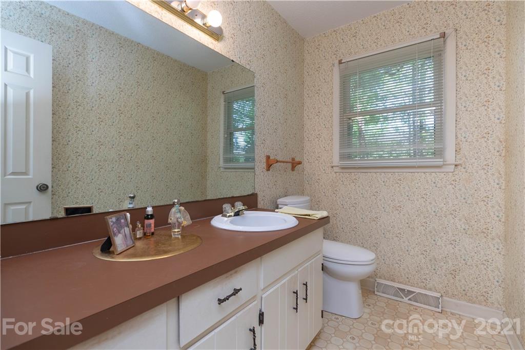11 Friendfield Court Fort Mill, SC 29715 - Photo 17 of 32 a bathroom with a granite countertop sink a toilet and mirror