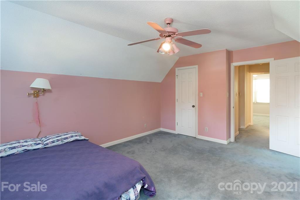 11 Friendfield Court Fort Mill, SC 29715 - Photo 18 of 32 a bedroom with a bed and a chandelier fan