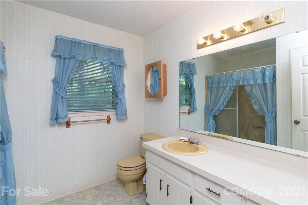 11 Friendfield Court Fort Mill, SC 29715 - Photo 19 of 32 a bathroom with a granite countertop bathtub sink vanity mirror and toilet