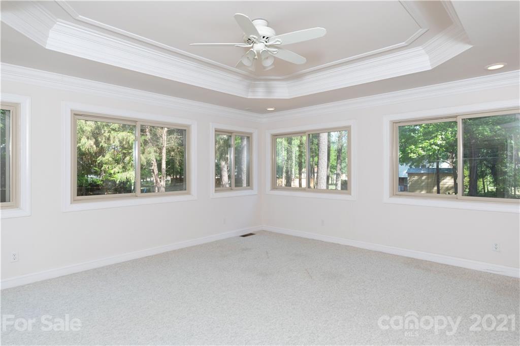 11 Friendfield Court Fort Mill, SC 29715 - Photo 21 of 32 an empty room with windows and chandelier fan