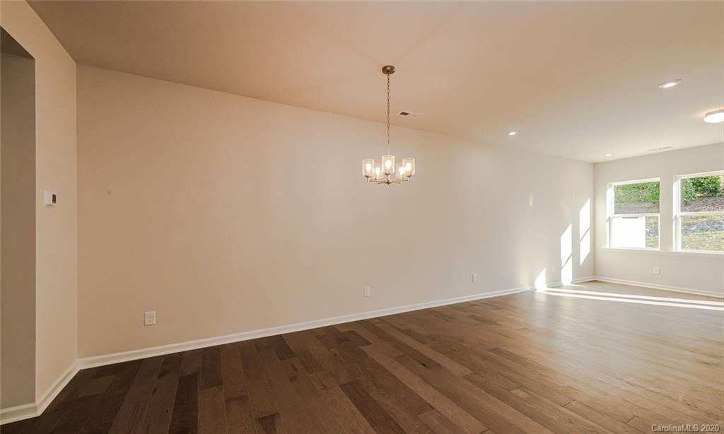 512 Madison Falls, Unit 6 Fort Mill, SC 29708 - Photo 11 of 27 a view of an empty room with wooden floor and windows
