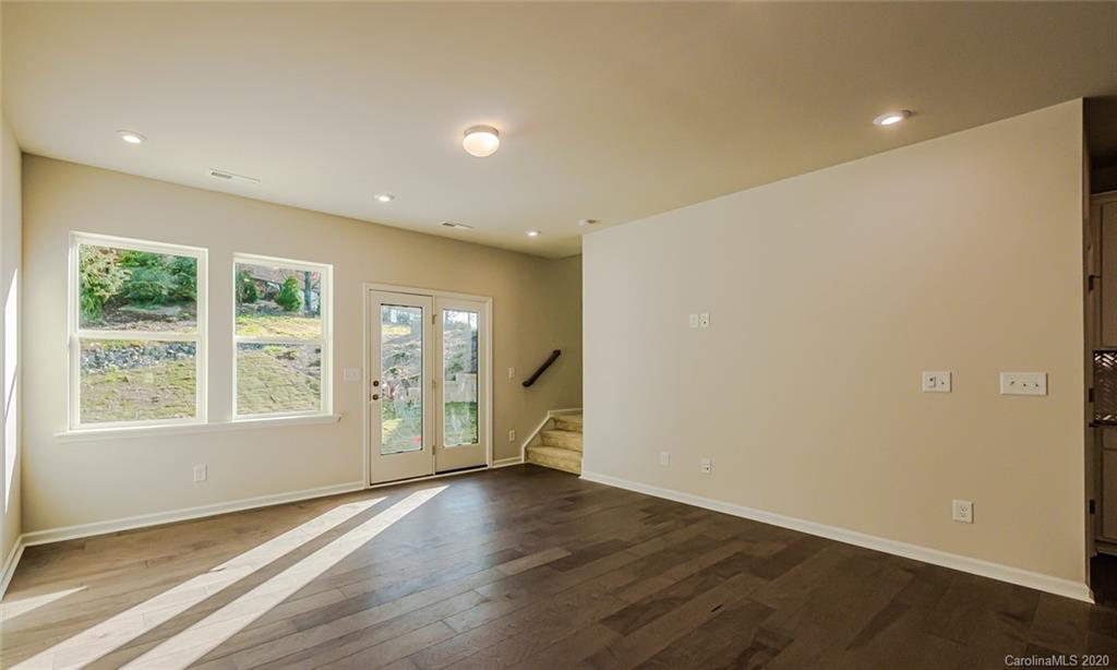 512 Madison Falls, Unit 6 Fort Mill, SC 29708 - Photo 13 of 27 an empty room with wooden floor and windows