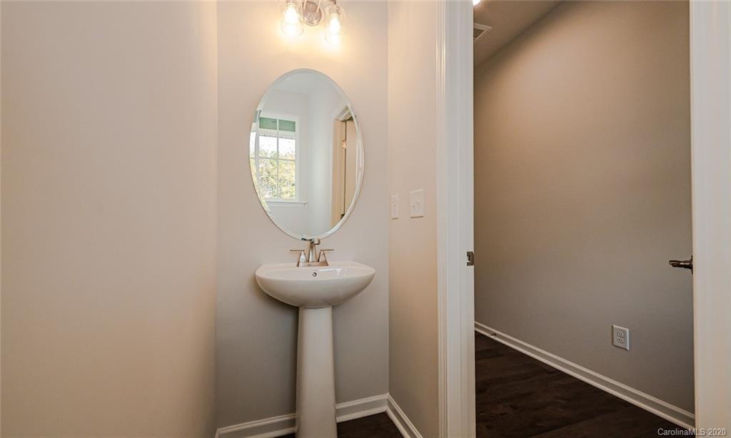 512 Madison Falls, Unit 6 Fort Mill, SC 29708 - Photo 15 of 27 a view of a hallway with wooden floor and a mirror