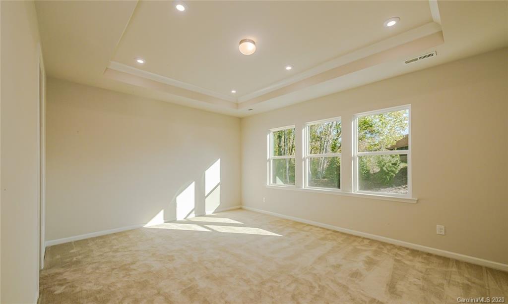512 Madison Falls, Unit 6 Fort Mill, SC 29708 - Photo 17 of 27 an empty room with a fireplace and windows