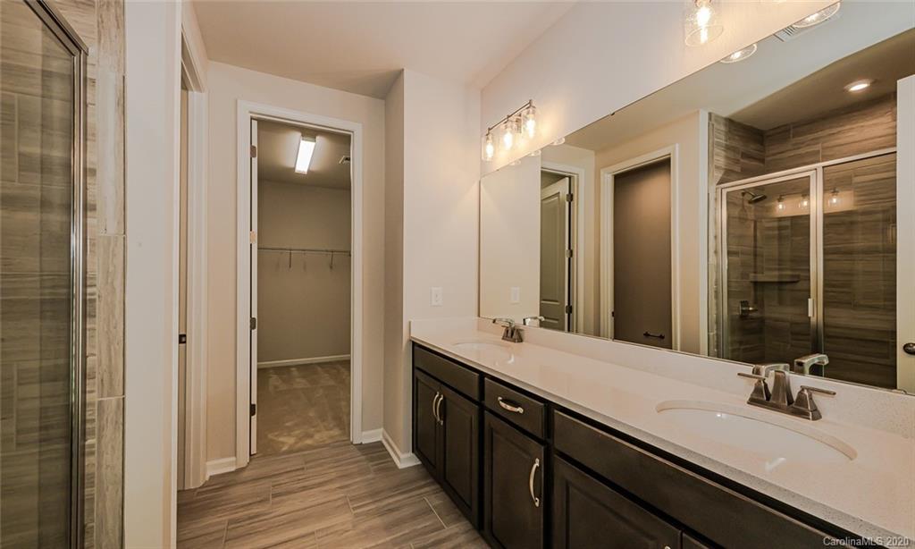 512 Madison Falls, Unit 6 Fort Mill, SC 29708 - Photo 19 of 27 a bathroom with a double vanity sink and a mirror
