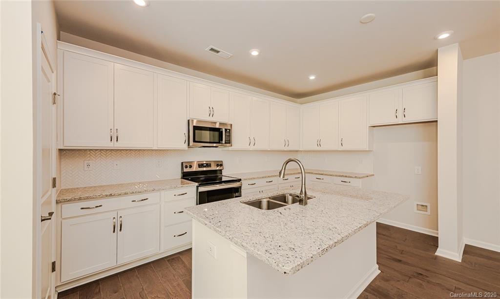 512 Madison Falls, Unit 6 Fort Mill, SC 29708 - Photo 7 of 27 a kitchen with white cabinets and white appliances