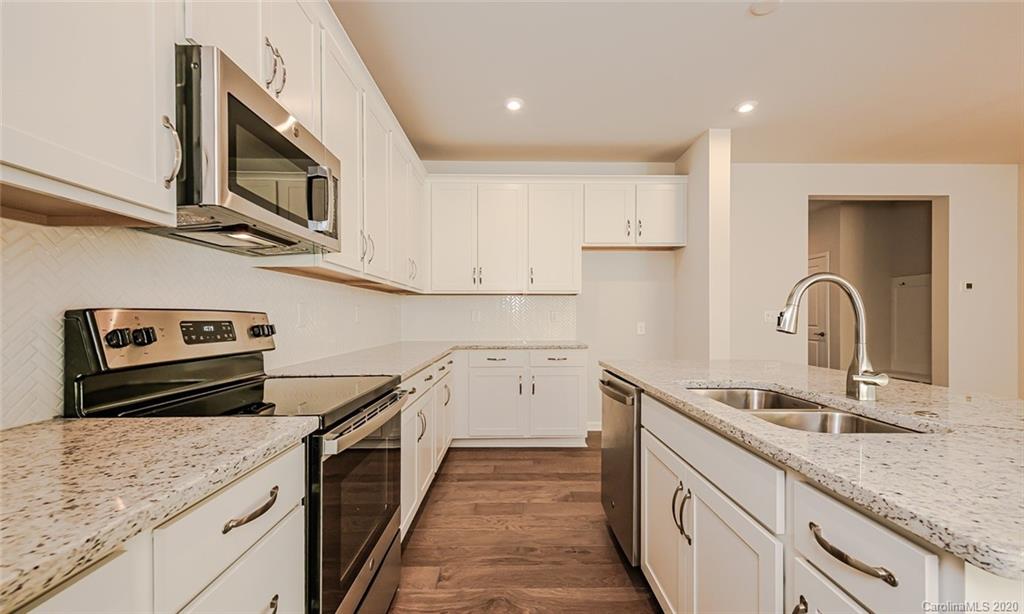512 Madison Falls, Unit 6 Fort Mill, SC 29708 - Photo 9 of 27 a kitchen with a sink cabinets and stainless steel appliances