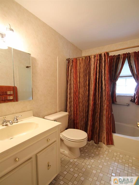 10 Louise Road Edison, NJ 08817 - Photo 11 of 17 a bathroom with a sink a toilet a tub and shower