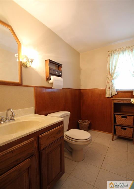 10 Louise Road Edison, NJ 08817 - Photo 12 of 17 a bathroom with a sink a toilet and a mirror