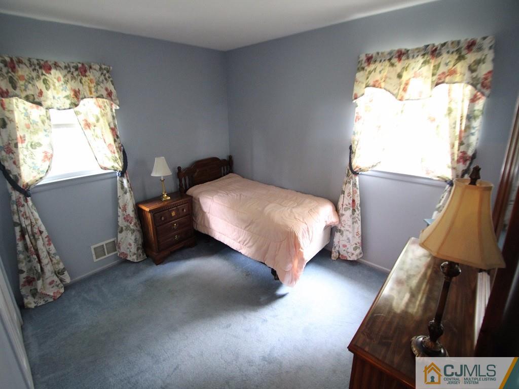 10 Louise Road Edison, NJ 08817 - Photo 13 of 17 a bedroom with a bed and window