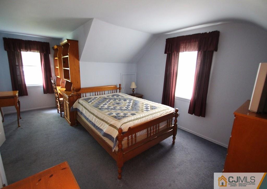 10 Louise Road Edison, NJ 08817 - Photo 14 of 17 a bedroom with a bed and a mirror