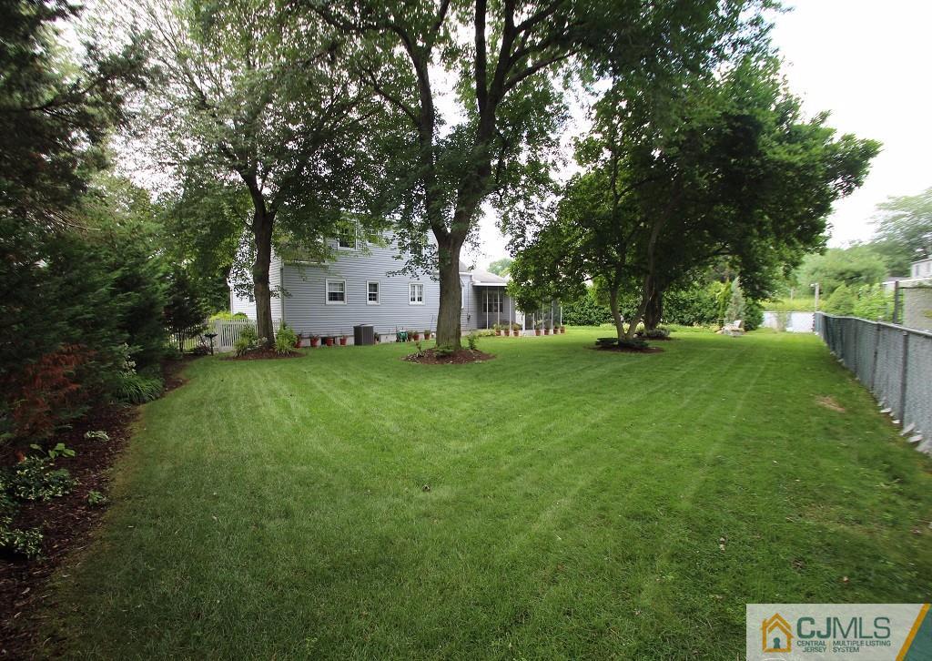 10 Louise Road Edison, NJ 08817 - Photo 16 of 17 a picture of trees with a big yard