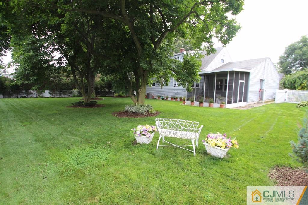 10 Louise Road Edison, NJ 08817 - Photo 17 of 17 a view of a table and chairs in the garden