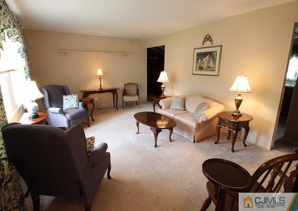 10 Louise Road Edison, NJ 08817 - Photo 3 of 17 a living room with furniture and a lamp