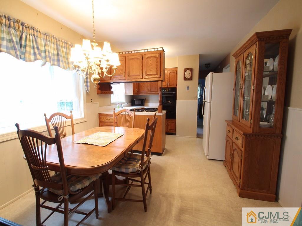 10 Louise Road Edison, NJ 08817 - Photo 5 of 17 a view of a dining room with furniture a chandelier and wooden floor
