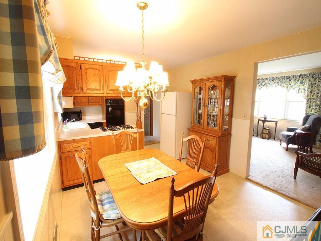 10 Louise Road Edison, NJ 08817 - Photo 9 of 17 a view of a dining room with furniture and a chandelier