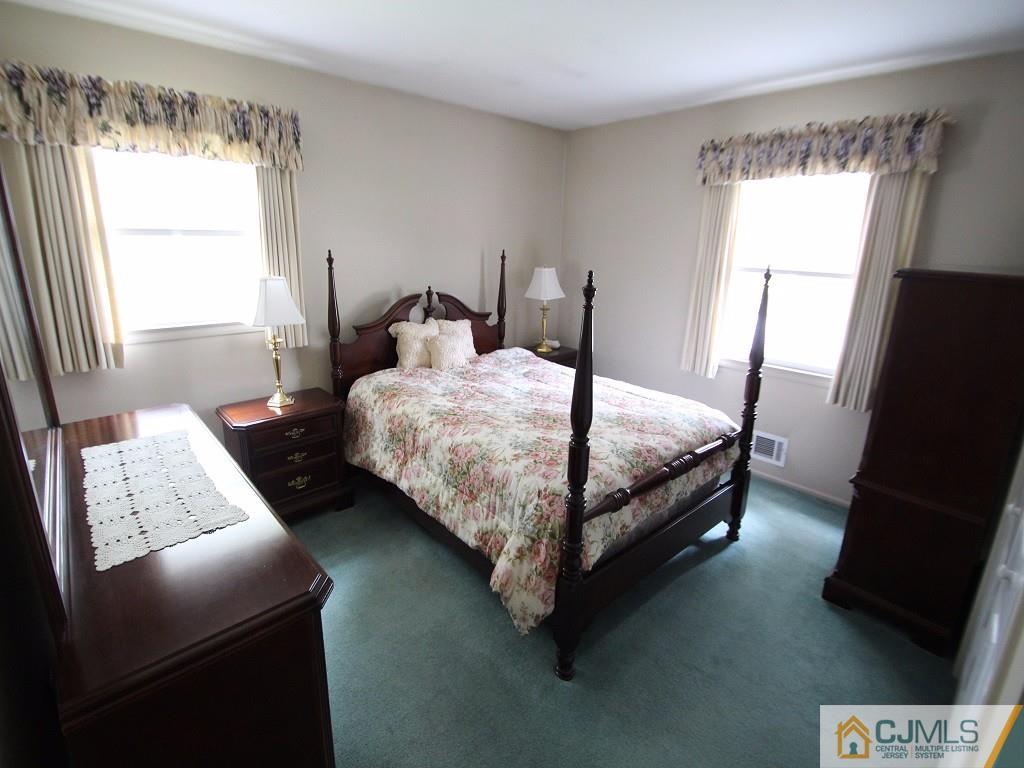 10 Louise Road Edison, NJ 08817 - Photo 10 of 17 a bedroom with a bed chair and window
