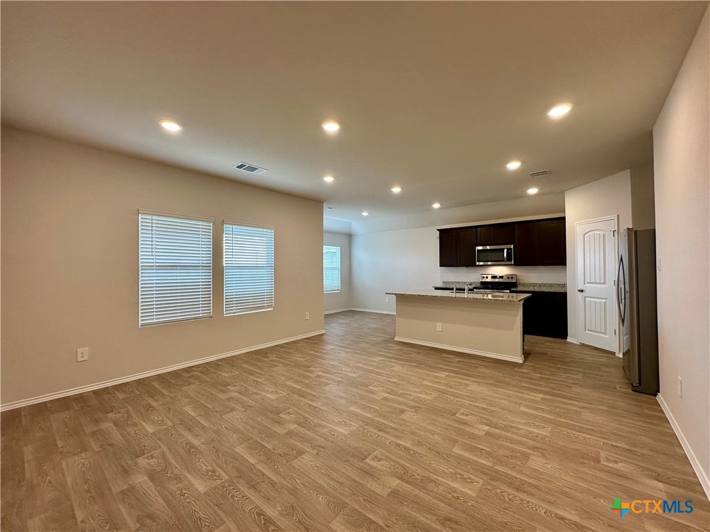 713 Signe Seguin, TX 78155 - Photo 11 of 18 a view of kitchen with kitchen island a sink stainless steel appliances and cabinets