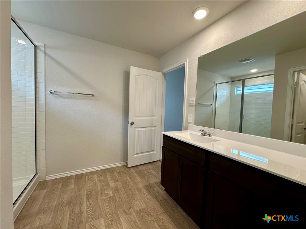 713 Signe Seguin, TX 78155 - Photo 14 of 18 a bathroom with a double vanity sink and mirror