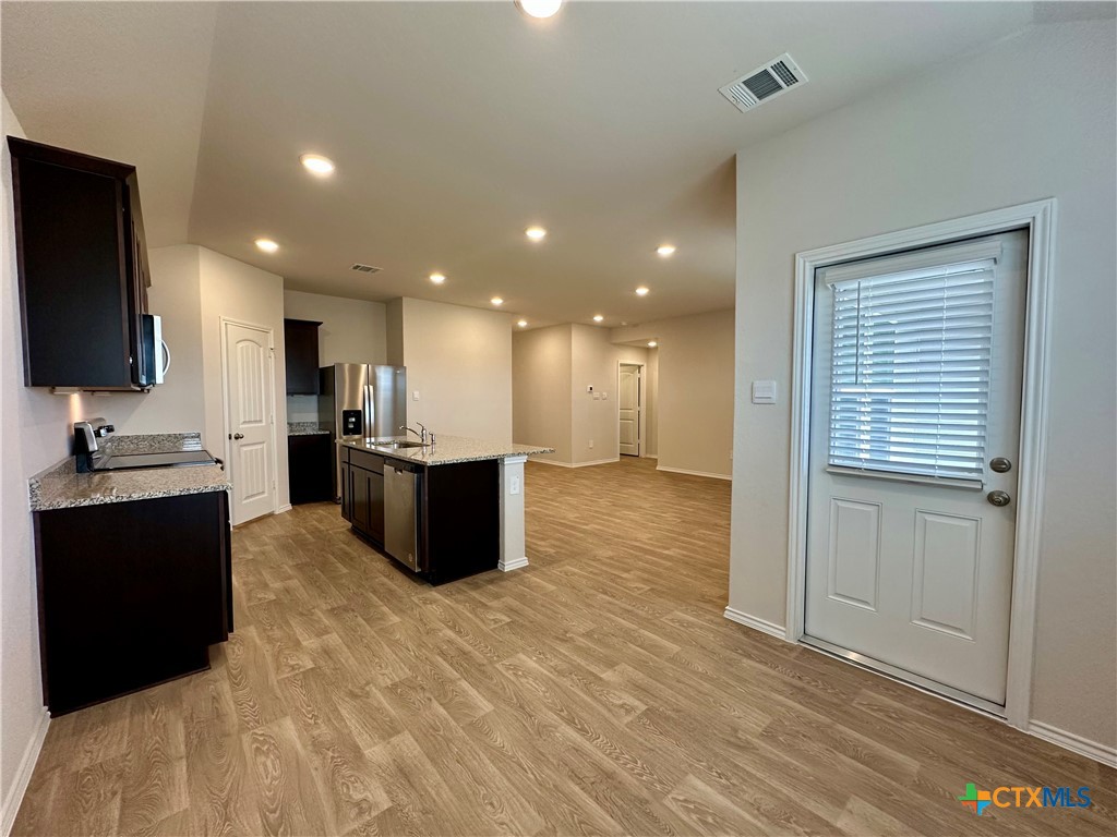 713 Signe Seguin, TX 78155 - Photo 5 of 18 a large kitchen with stainless steel appliances kitchen island granite countertop a large counter top and a stove