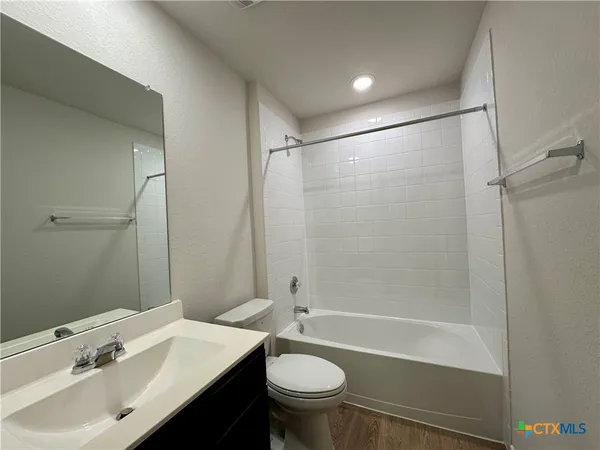 a view of kitchen with kitchen island a sink stainless steel appliances and cabinets